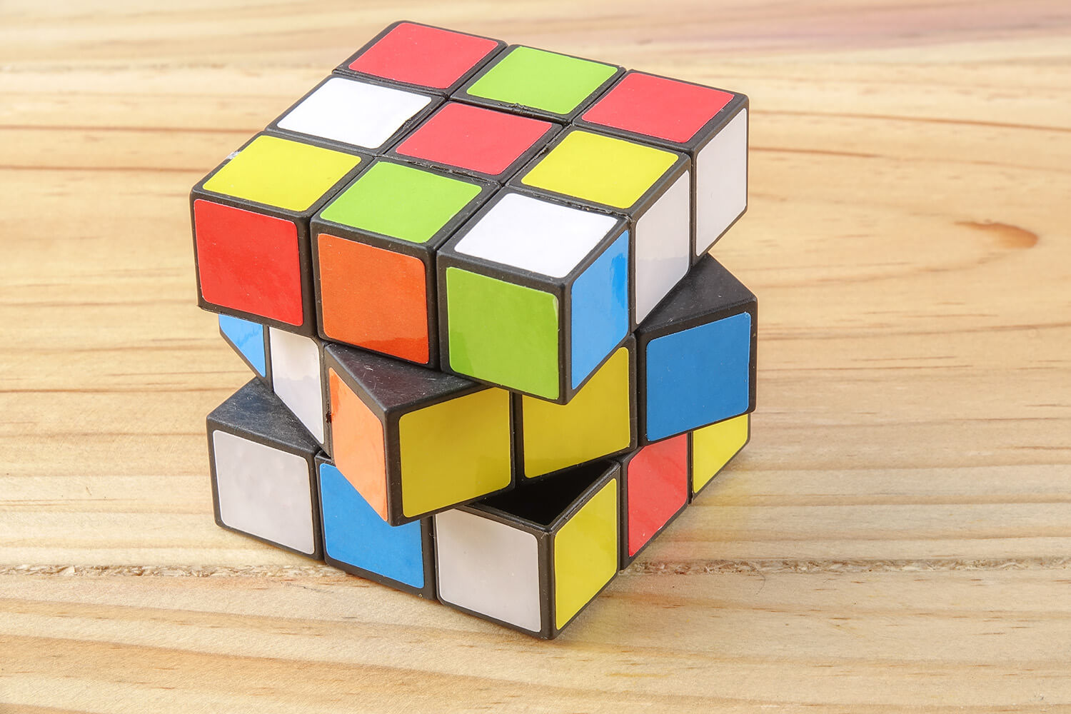 Partially-solved Rubiks Cube sitting on a table